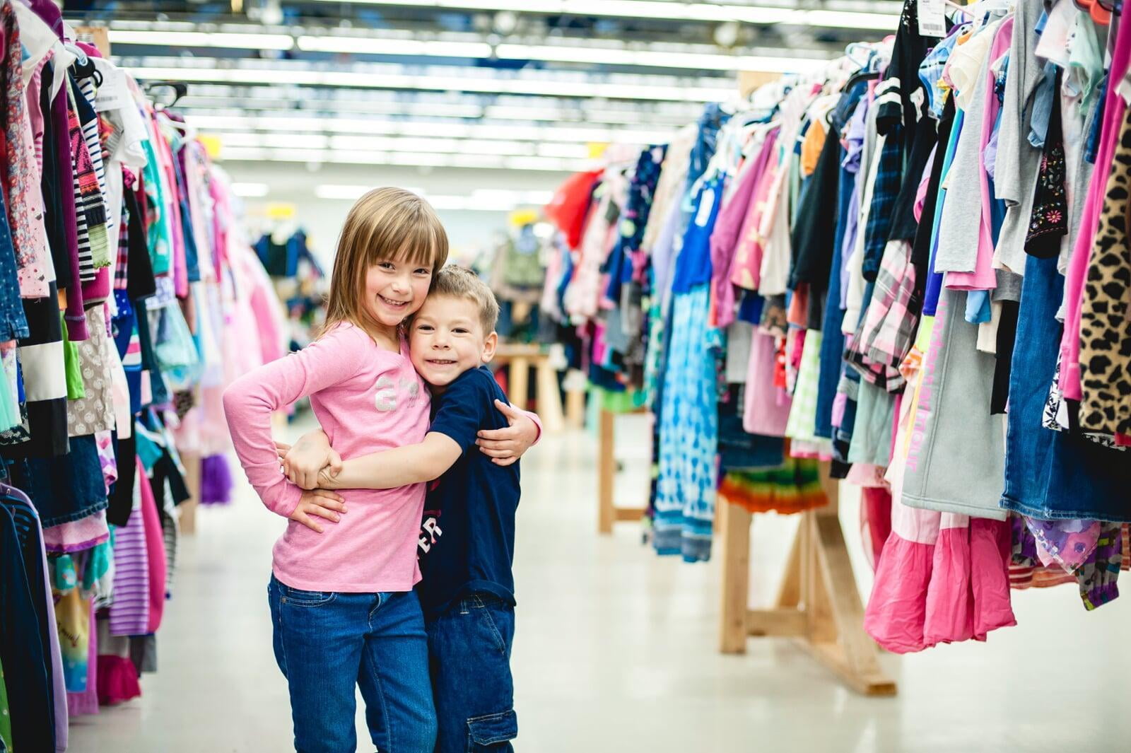 A masked Team Member with gloves helps out at a local JBF sale.